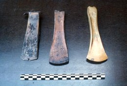 Various stages in manufacturing a bronze axe.